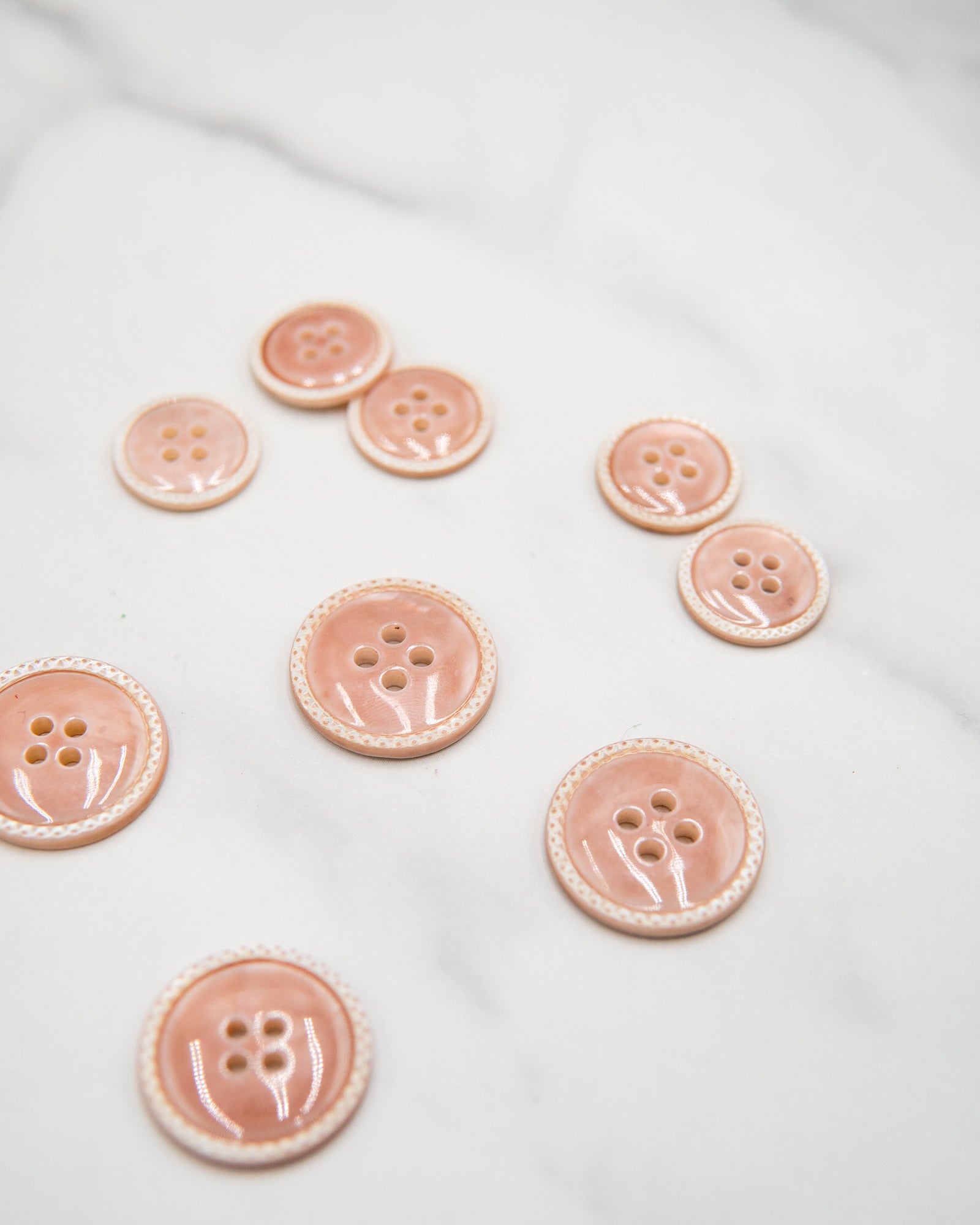 Glossy pale river shell buttons with textured edge