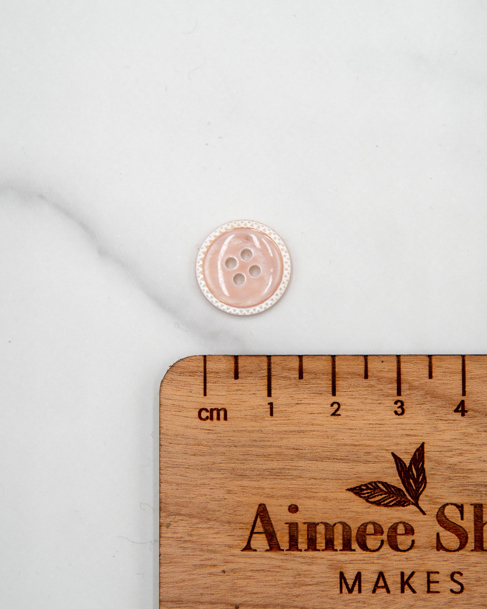 Glossy pale river shell buttons with textured edge