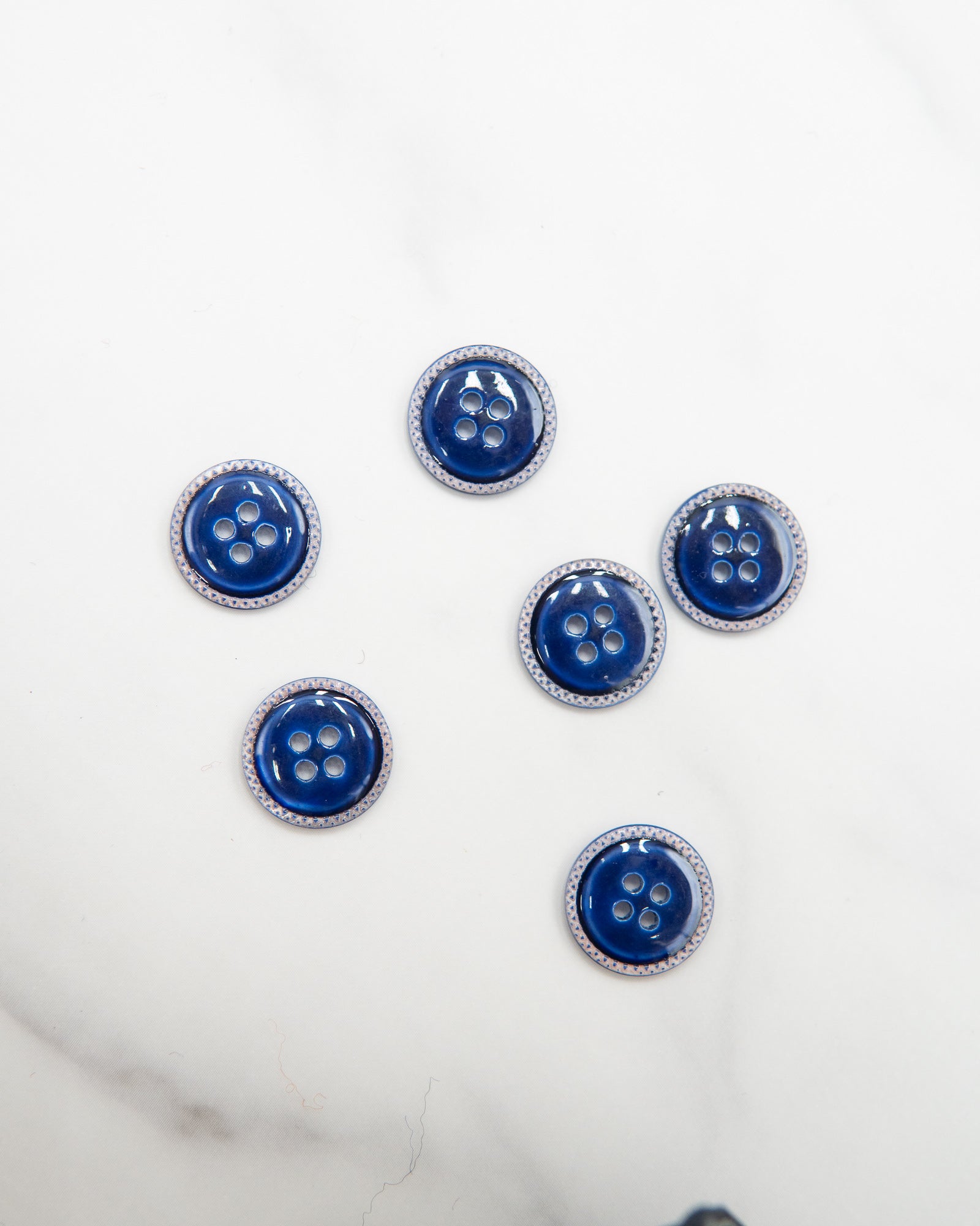 Glossy pale river shell buttons with textured edge
