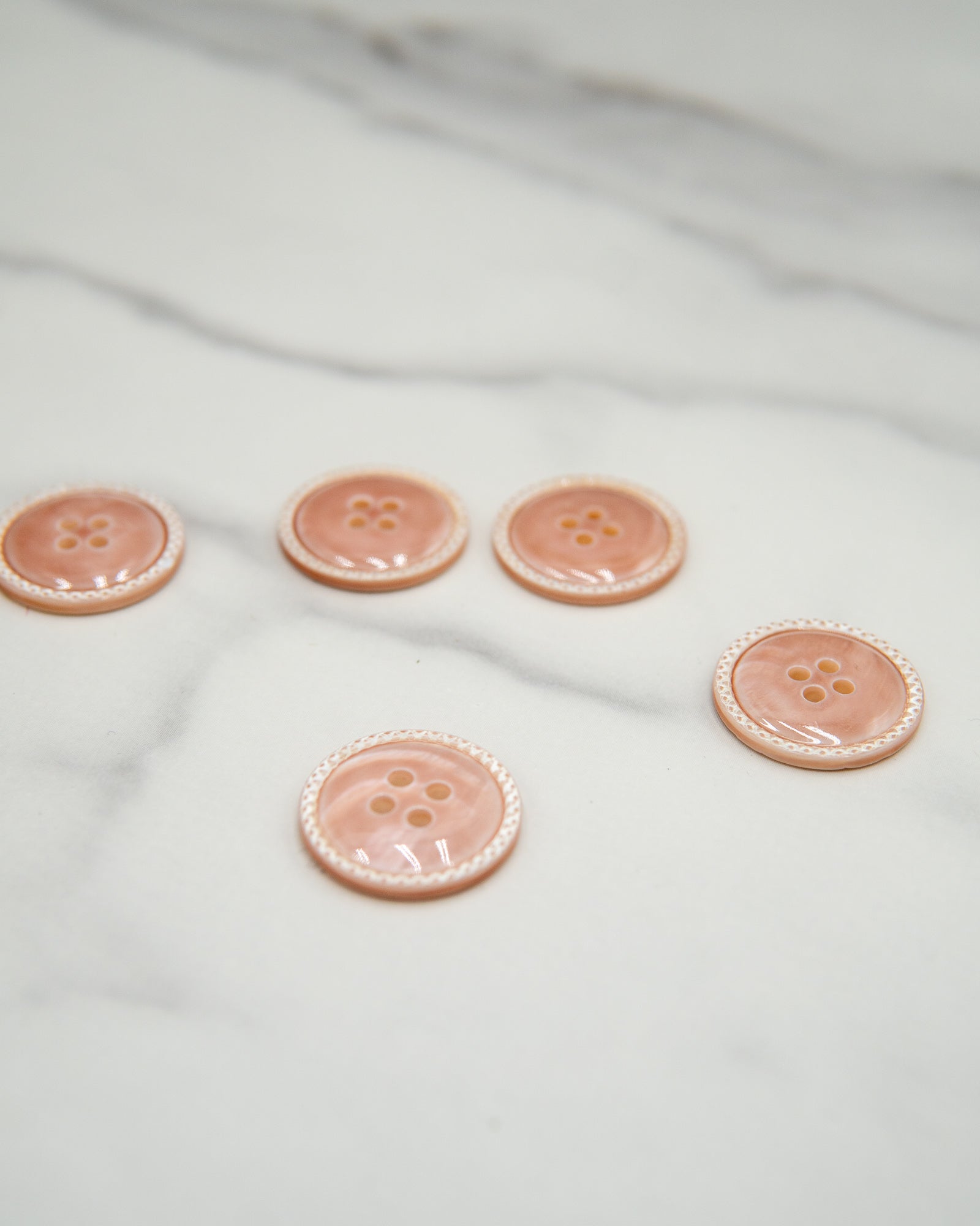 Glossy pale river shell buttons with textured edge