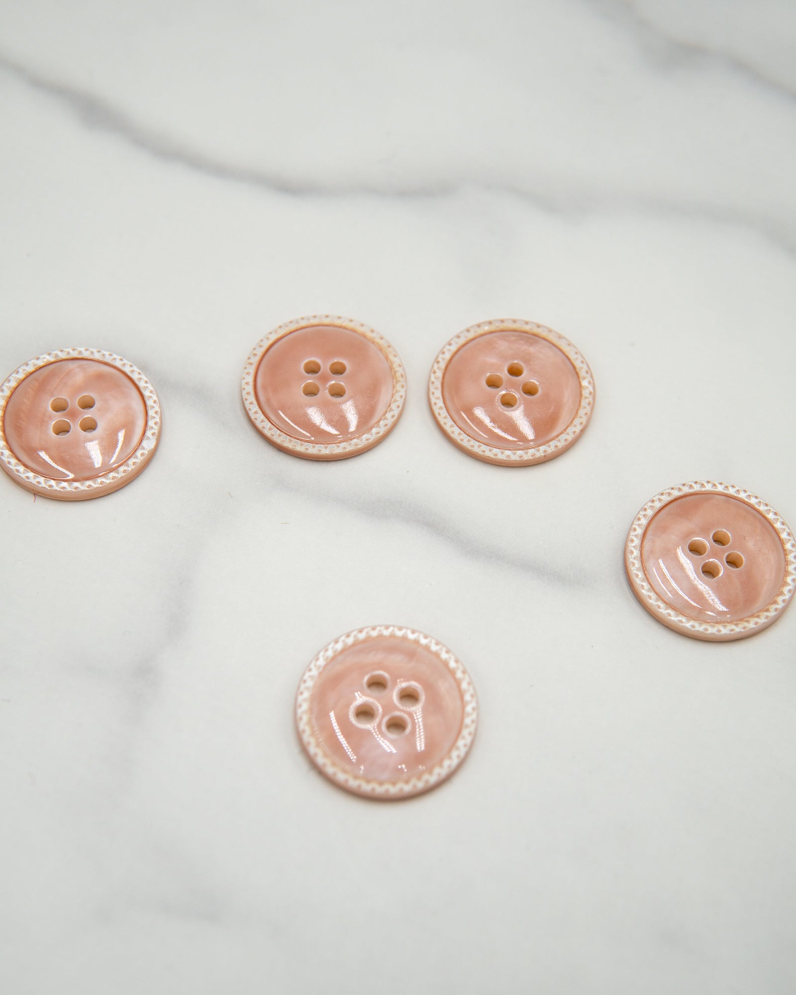 Glossy pale river shell buttons with textured edge