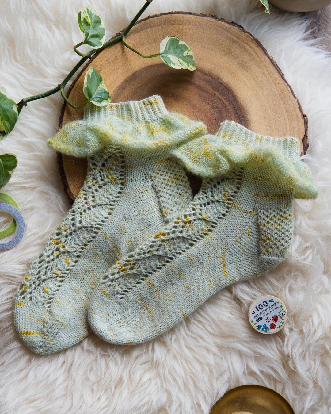 Lace sock knitting pattern with ruffle. 